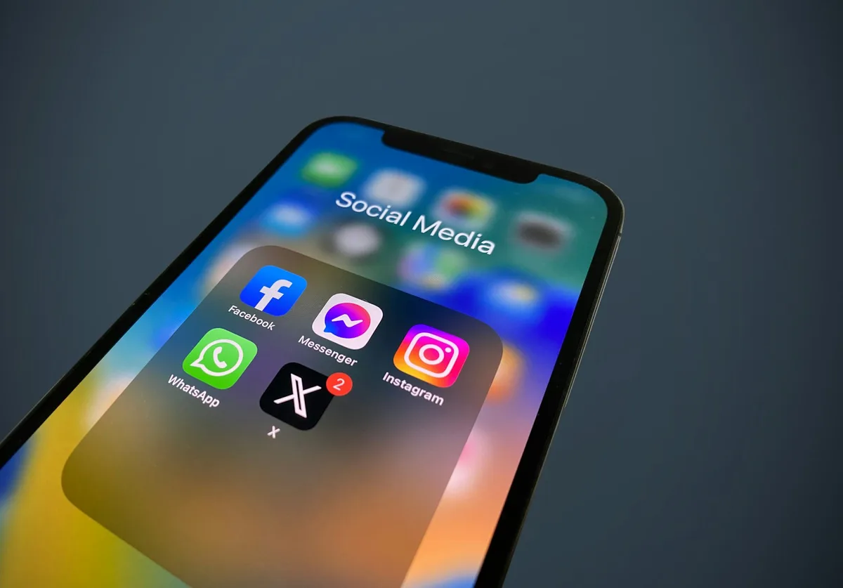 Close-up of a smartphone screen showing a folder of social media app icons